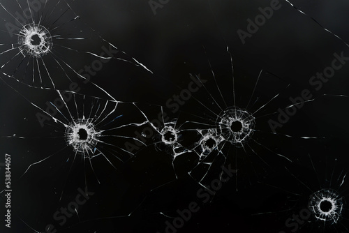 Fotobehang bullet hole on glass black background for overlay, transparent window
