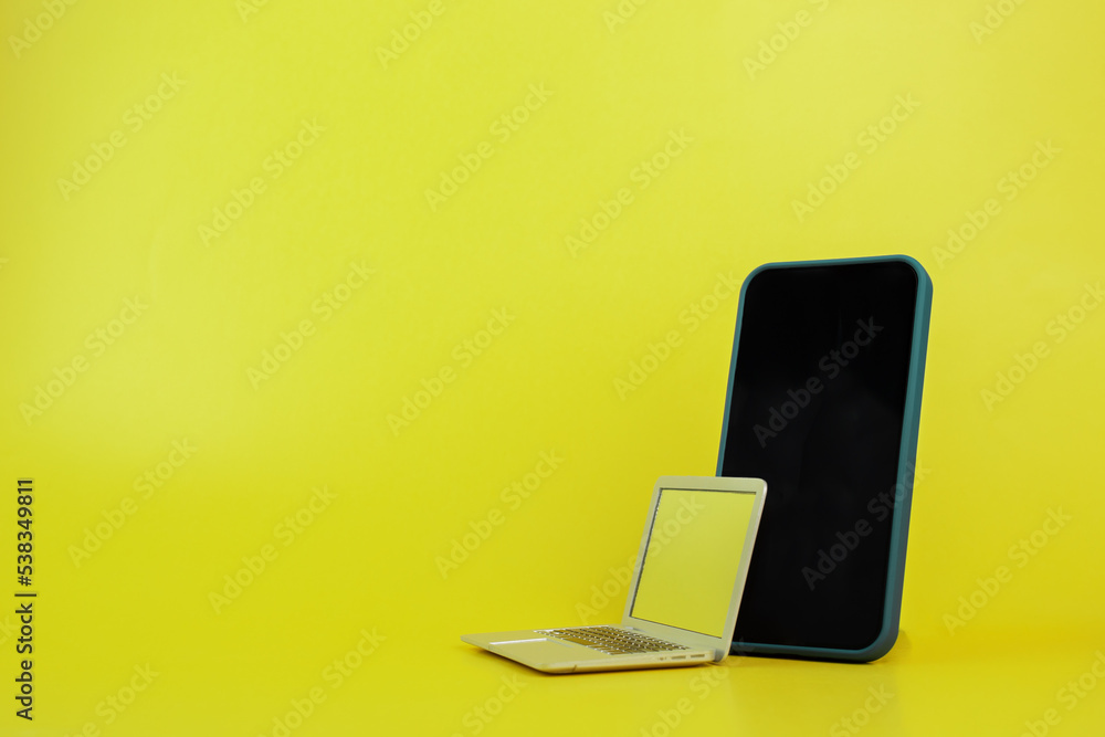 black Friday, sale and discount,phone and laptop on yellow background, copy space black Friday, sale and discount,phone and laptop on yellow background, copy space