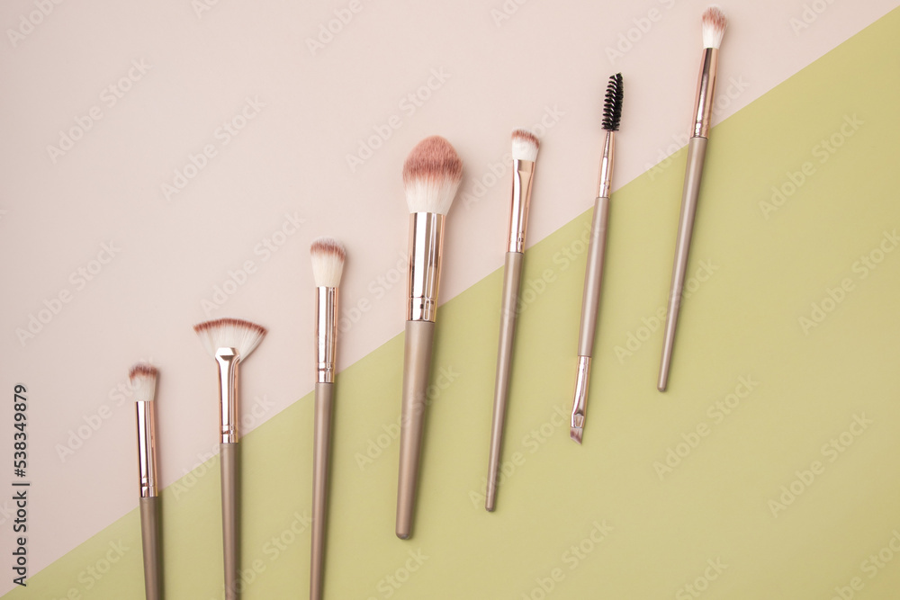 makeup brushes, Set of professional decorative cosmetics, beauty accessories on a beige background