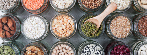 Vegan source of protein. assortment of healthy vegetarian food. top view of seeds, nuts, peas, beans, rice, spelt, oatmeal on white background banner