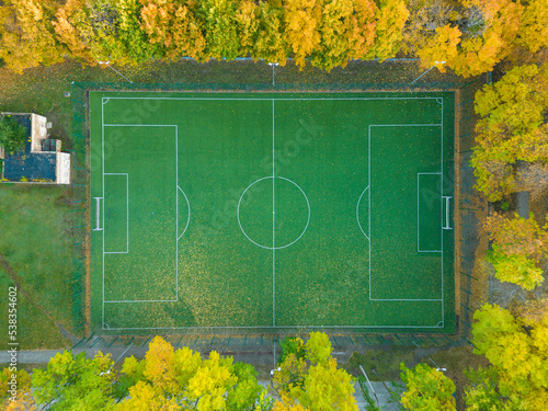 The concept of sports. Sports ground. Street football. Autumn trees near the football field. A bird's-eye view of the sports field from above. Street sports.