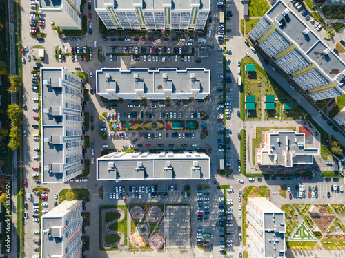 The concept of a residential neighborhood. Bird's-eye view of the playground in the courtyard of multi-storey buildings. New colorful houses. Top view