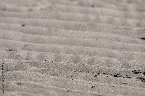 Texture of beach sand that make a wave pattern