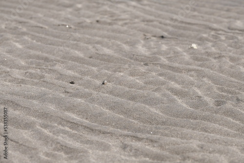 Texture of beach sand that make a wave pattern