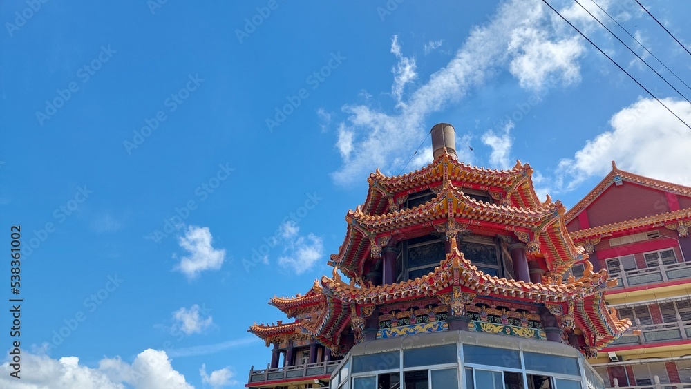 Fototapeta premium religious oriental sculpture on the roof of Taiwan temple with blue sky design for holy and belief concept