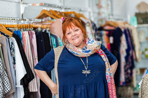Smiling portrait of a happy middle aged woman in clothing boutique store