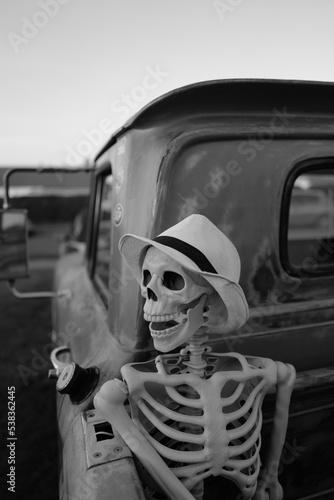 person in a car, Skeleton figure in rear of American pickup truck 