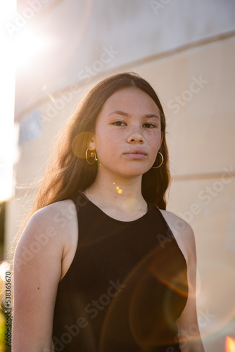 urban sunflare over mixed race teen girl photo