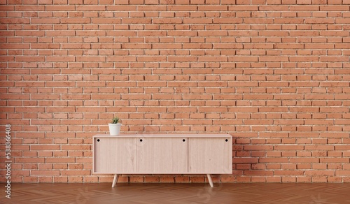 Brick wall interior with sideboard and plant pot photo