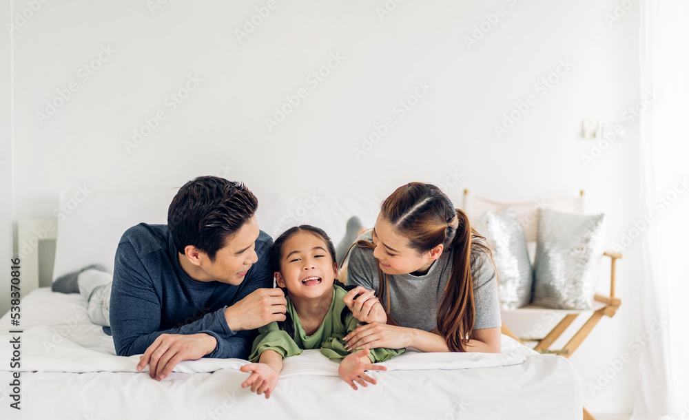 Portrait of enjoy happy love asian family father and mother holding hug cute little asian girl child smiling play and having fun moments good time in at home. Portrait of enjoy happy love asian family father and mother holding hug cute little asian girl child smiling play and having fun moments good time in at home.