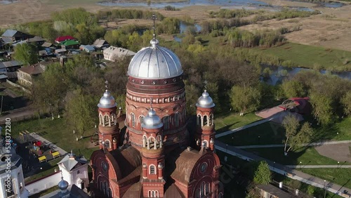 Fly out of historic church in town on sunny day photo