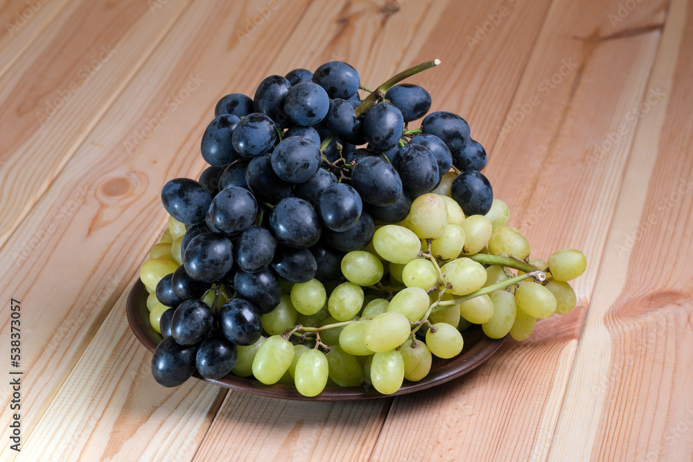 Sweet ripe white and black unwashed grapes Sweet ripe white and black unwashed grapes