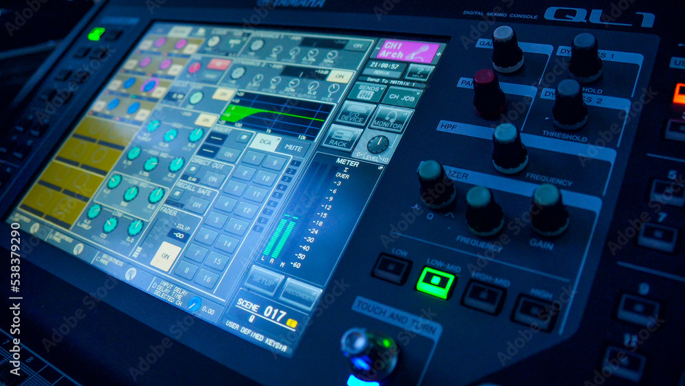 Professional instrumental sound engineer in a TV studio or at a concert. Video production. Record. Close-up music digital mixer for stage setup. Video recording. Video camera.