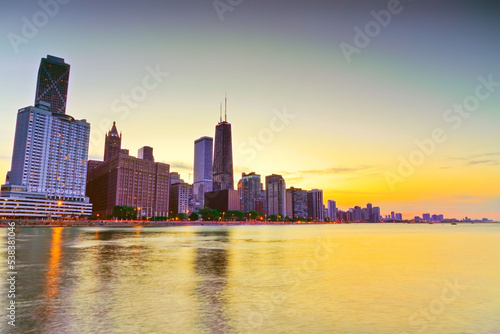 View of Chicago skyline from the shore of Lake Michigan at sunset. © Javen