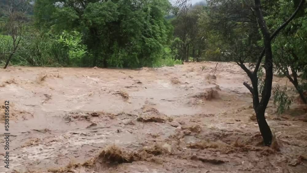 Flash flood, flood waters rushing down the river after the storm flows through. Flash flood, flood waters rushing down the river after the storm flows through.