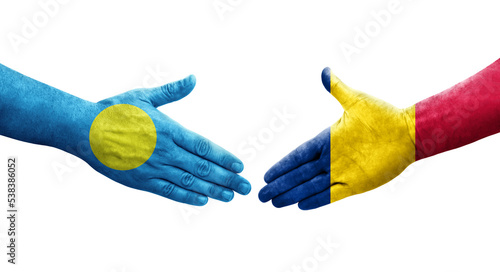 Handshake between Chad and Palau flags painted on hands, isolated transparent image.