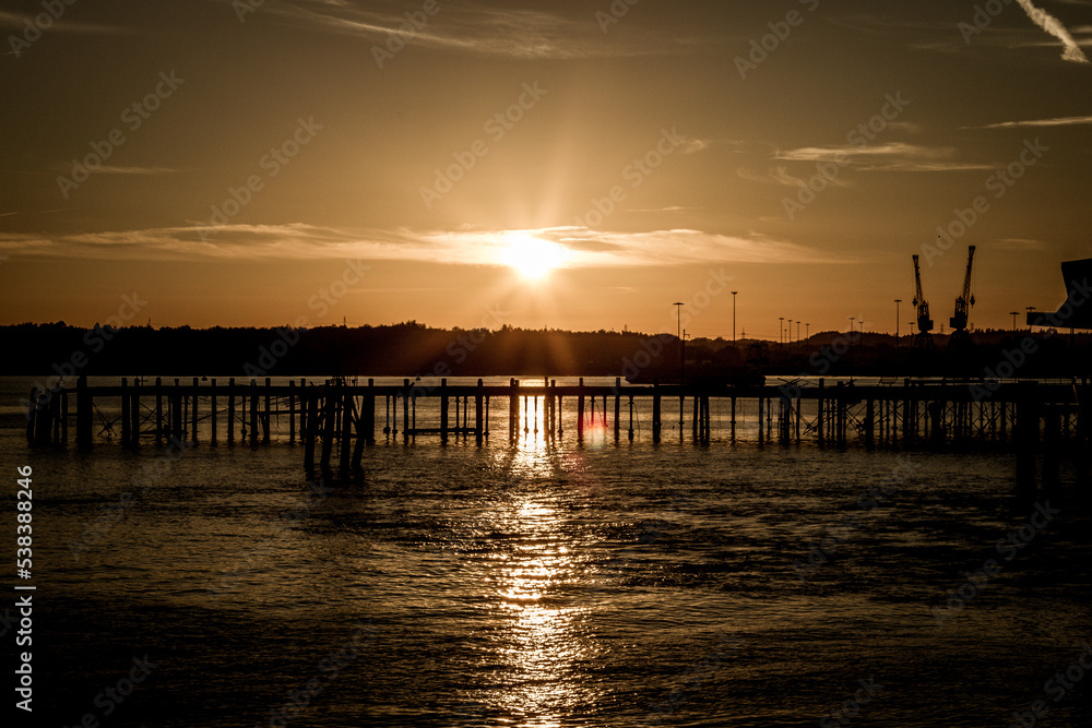 Fototapeta premium Landscape shots of a sunset over the docks in Southampton