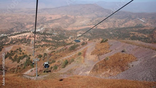 Autumn, 2022 - Uzbekistan, Amirsoy - View from the lift cabin. New ski resort Amirsoy in Uzbekistan. The lift cabin slowly rises uphill. photo