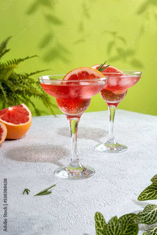 Summer refreshing sparcling cocktails with grapefruit. Lemonade garnished with fresh rosemary. Summer beverage with sparkling water and grapefruit slices. Summer refreshing sparcling cocktails with grapefruit. Lemonade garnished with fresh rosemary. Summer beverage with sparkling water and grapefruit slices.