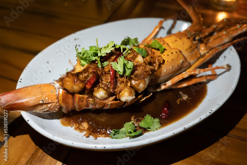 Thai lobster with tamarind sauce and on top with corianders photo