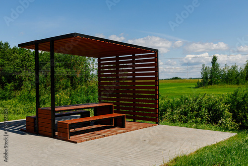 Wooden shelter or hut in the park with bench park