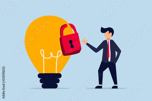 Intellectual property, patented protection, businessman owner standing with light bulb idea locked with padlock for patents.
