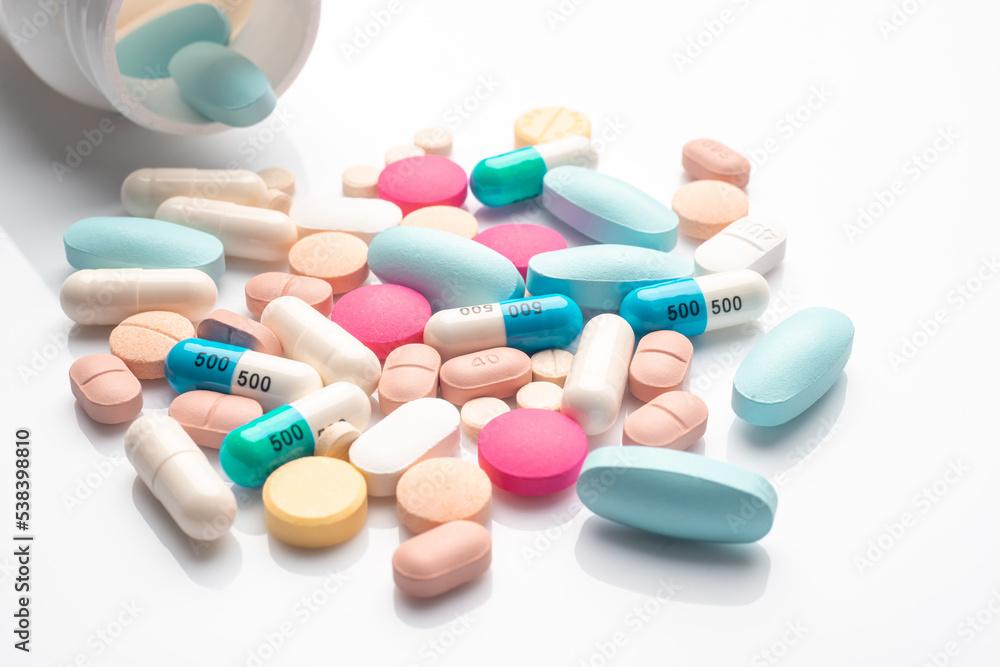 Vitamin, different color tablets and Pill capsule on white background, health care concept