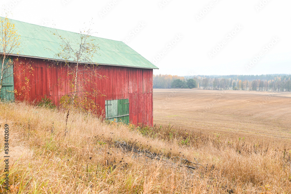 Red and green hay barn in the countryside Red and green hay barn in the countryside