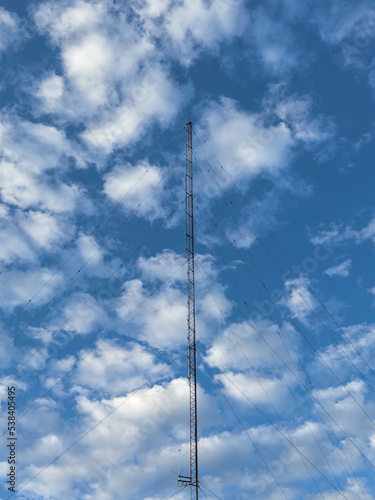 Telecommunications tower view with the background of the sky and clouds