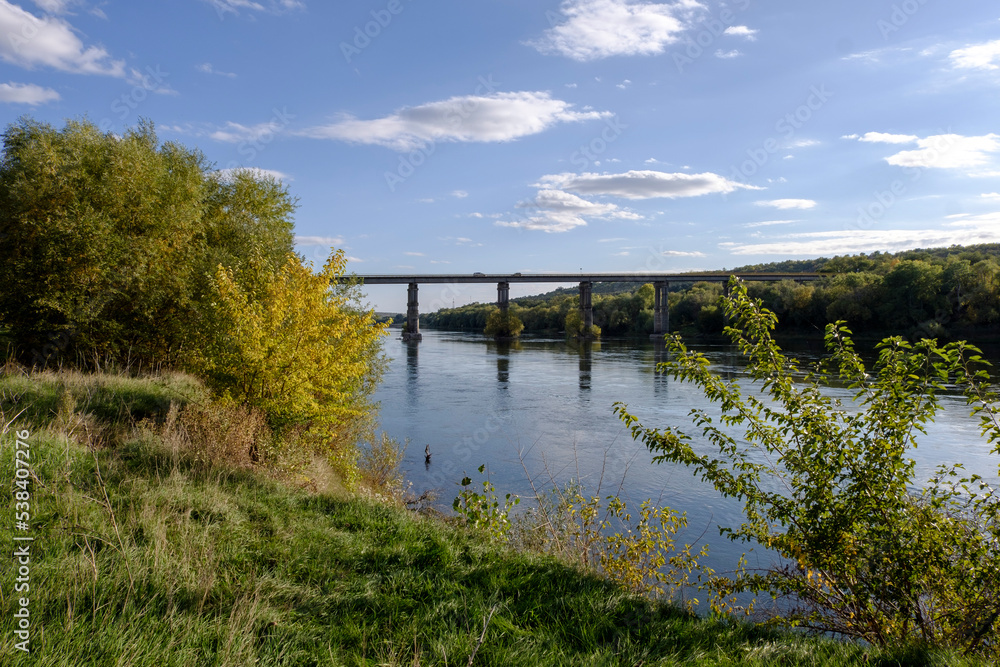 the old bridge over the river landscape in autumn