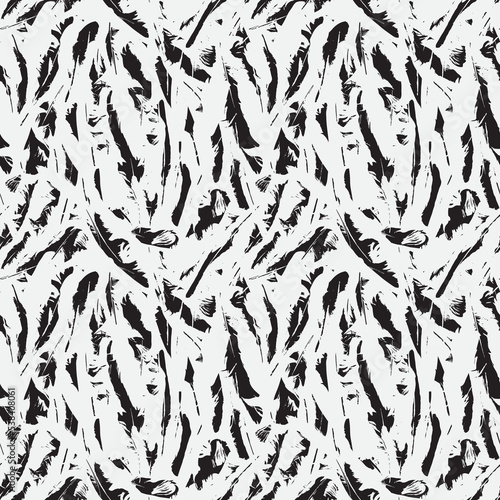 Abstract seamless pattern with chaotic scattered bird feathers. Monochrome vector background with black and white disheveled plumelets. Suitable for wallpaper, wrapping paper or fabric design