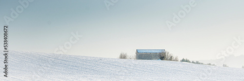 Winter landscape with a hermitage surrounded by snow.
 photo
