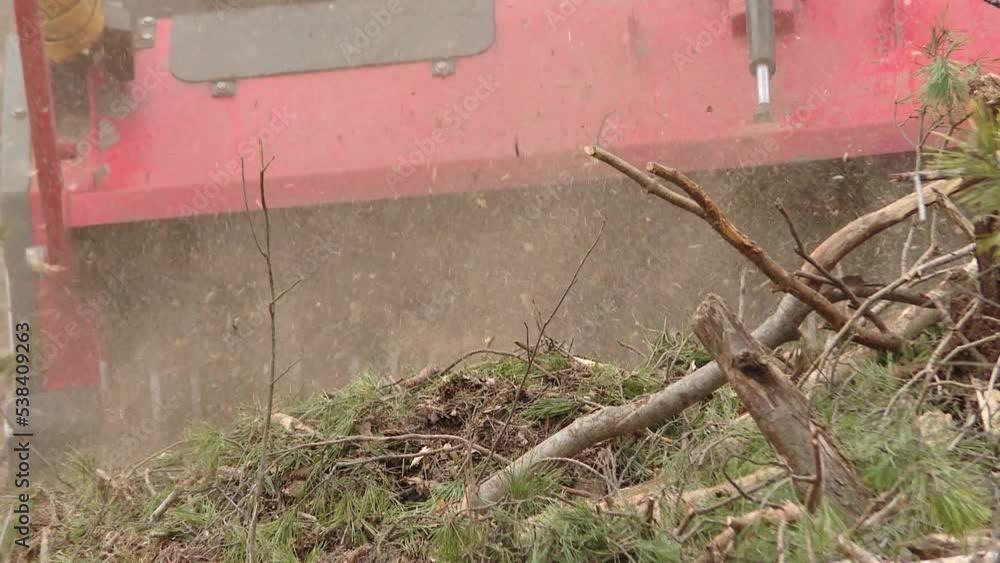 Wood Chipper in Action captures a wood chipper. Equipment for chopping