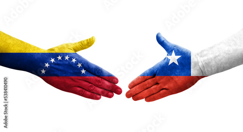 Handshake between Chile and Venezuela flags painted on hands, isolated transparent image.
