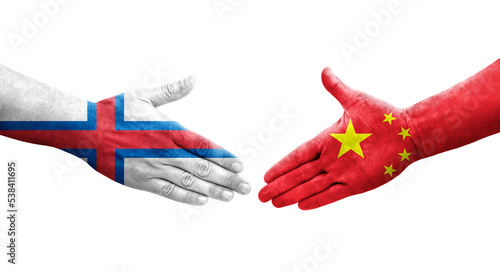 Handshake between China and Faroe Islands flags painted on hands, isolated transparent image.