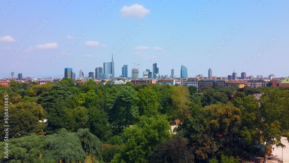 Aerial view of autumn trees in sempione park next to castello sforzesco castle. City and roofs of buildings. View of modern skyscrapers. Ecology. Green Planet. Skyline. Milan. Italy, Aerial view of autumn trees in sempione park next to castello sforzesco castle. City and roofs of buildings. View of modern skyscrapers. Ecology. Green Planet. Skyline. Milan. Italy,
