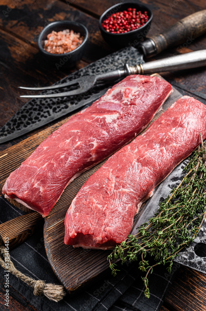 Raw lamb tenderloin fillet, Mutton fresh meat on butcher wooden board. Wooden background. Top view