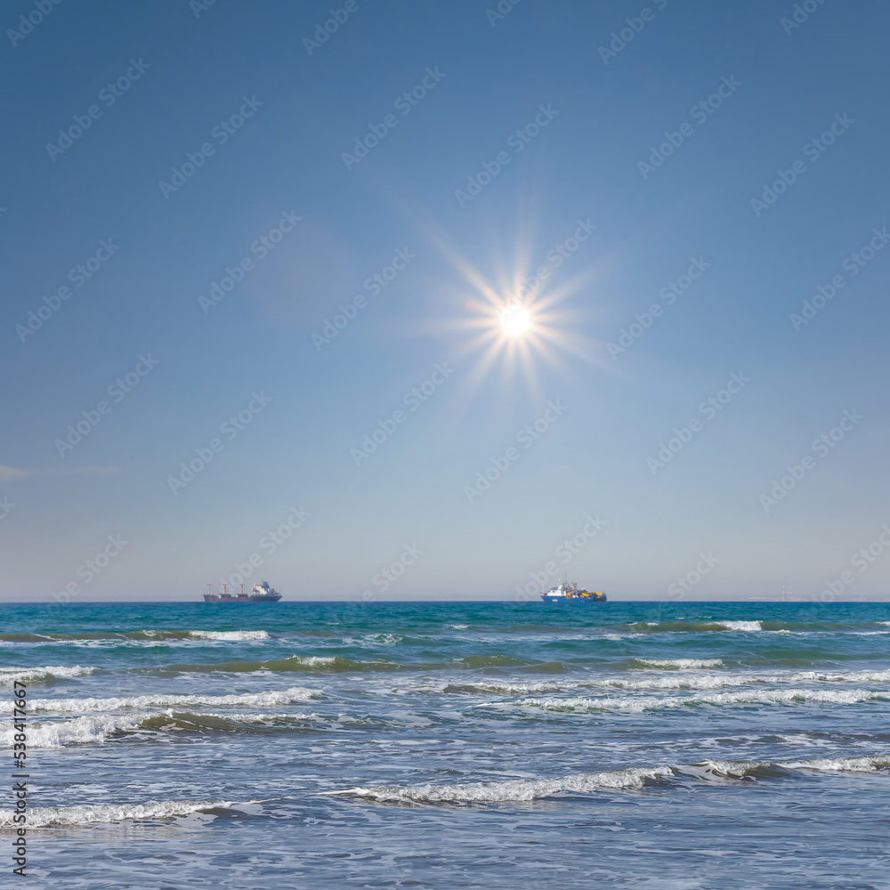sea coast with cargi ship at the storm, sea scape at sunny day