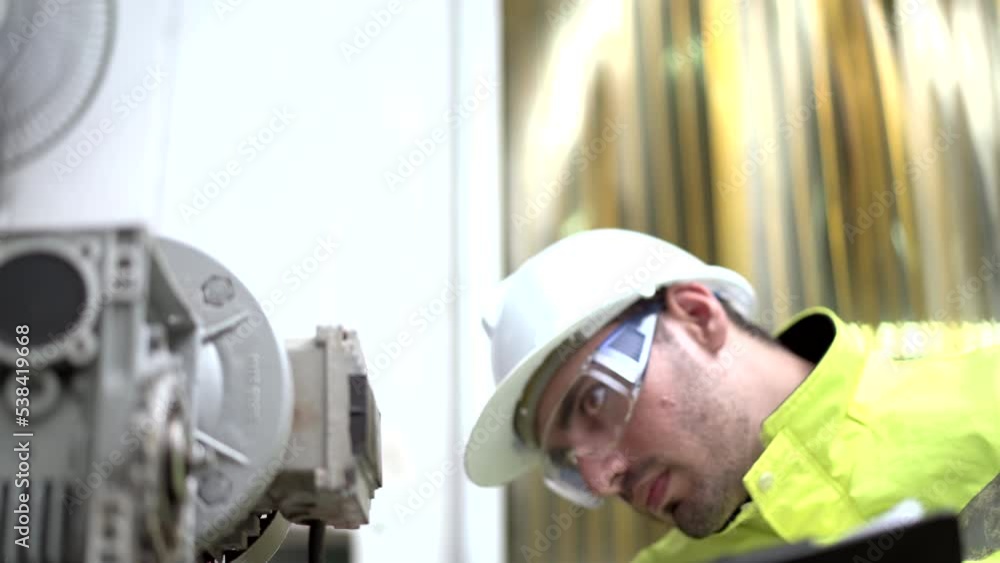 Industrial or machinery engineer inspecting and fixing the machines. Industrial or machinery engineer inspecting and fixing the machines.