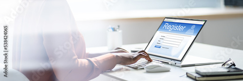 Businesswoman's Hand Filing Online Registration Form