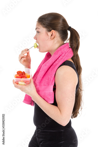 Young woman in sports wear with towel eating fresh fruit  isolated on transparent background