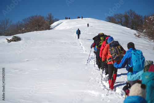 a group of mountaineers walking in the snow
