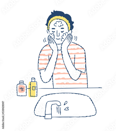 洗顔をしている若い男性
