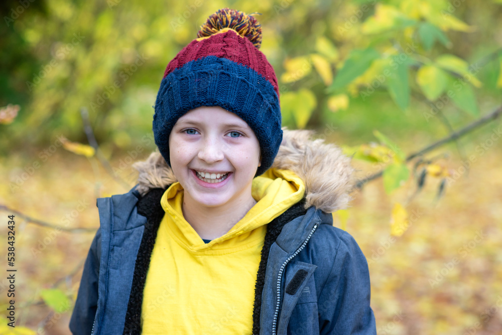 portrait of a happy schoolboy in a jacket with a backpack going to school in autumn portrait of a happy schoolboy in a jacket with a backpack going to school in autumn