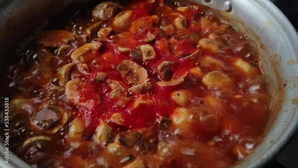 Preparing rich vegan red pozole, of mushrooms, in slow fire, boiling. Preparing rich vegan red pozole, of mushrooms, in slow fire, boiling.