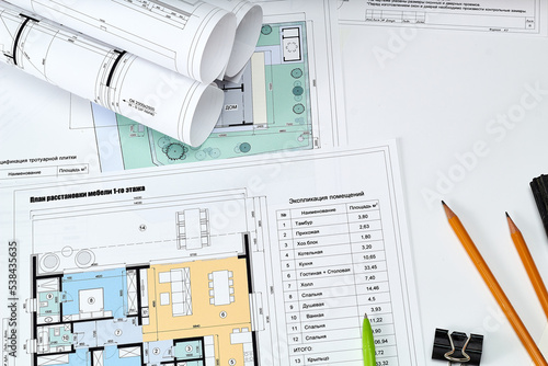 Working tools and drawings of the designer on a white background. Construction of houses, drawing, interior design.