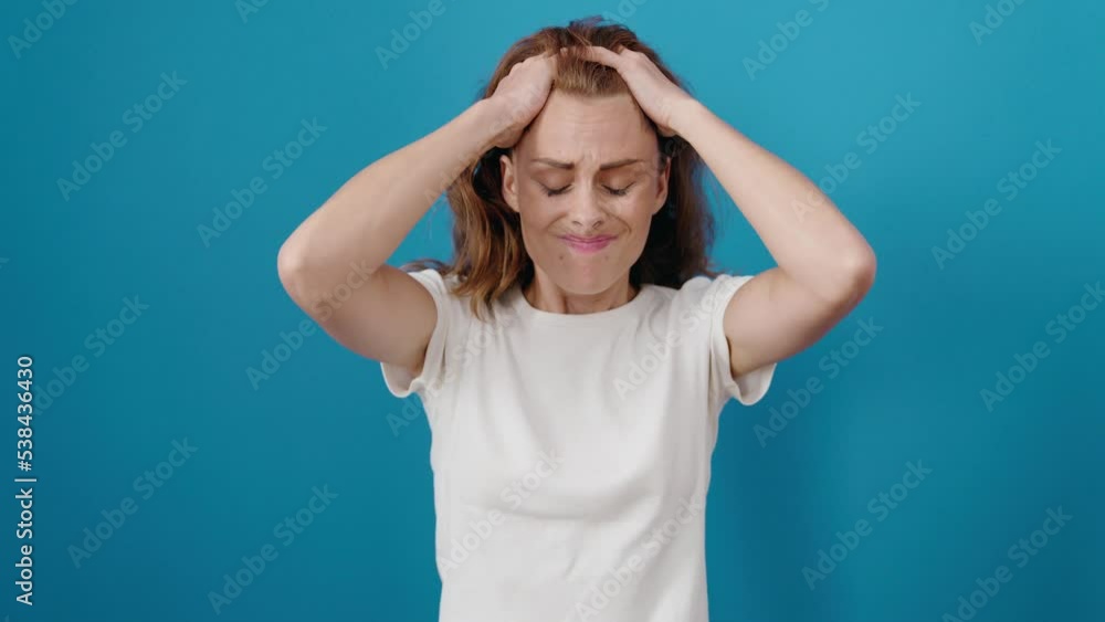 Young beautiful hispanic woman suffering for headache standing over isolated blue background Young beautiful hispanic woman suffering for headache standing over isolated blue background