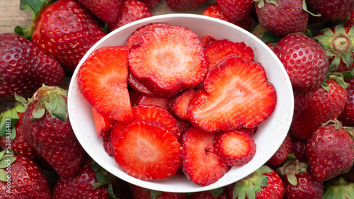 top view of boul of sliced ​​strawberries, and strawberries