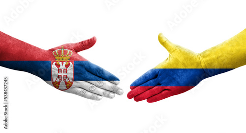 Handshake between Colombia and Serbia flags painted on hands, isolated transparent image.