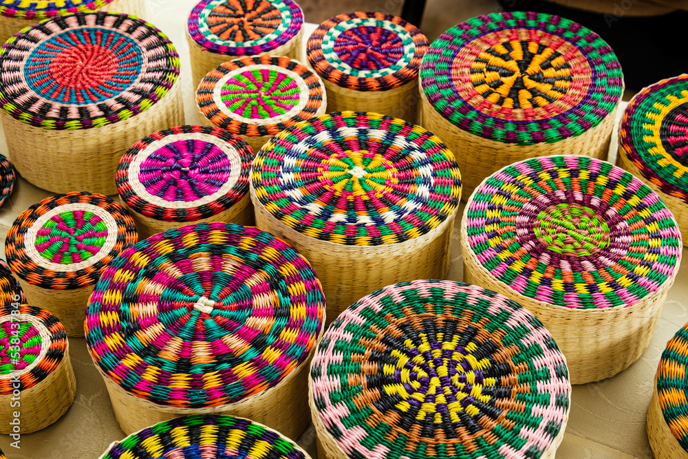 Wicker souvenirs baskets made from toquilla straw which is  vegetable fiber painted with various colors. Artisan market in Cuenca, Ecuador